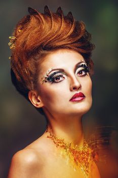 Close-up portrait of a young and attractive girl with hairstyle and jewelry