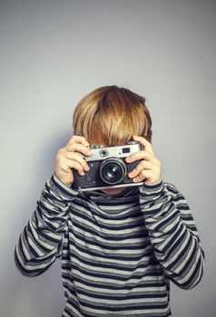 handsome boy with an old camera