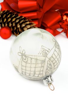 Handmade White Silk Christmas Ball with Silver Decoration on Holiday Ribbons and Baubles background closeup