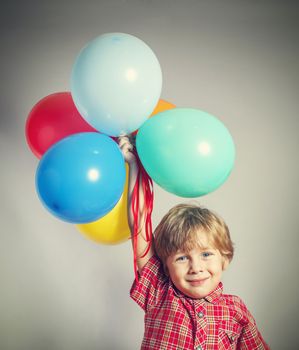 Child holding the bunch of balloons