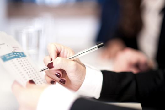 Closeup shot of female hands checking report