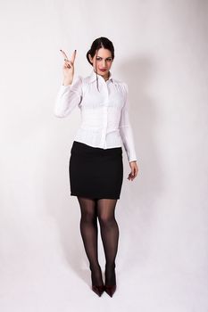 portrait of young business woman showing victory sign
