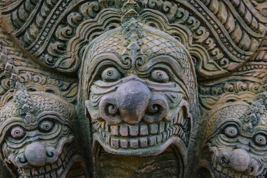 Stone statue on the wall of the temple in Thailand.
