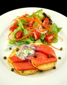 Corn fritters topped with smoked trout with dill, capers and cottage cheese.