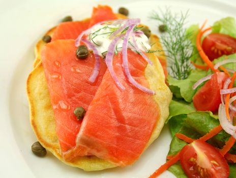 Corn fritters topped with smoked trout with dill, capers and cottage cheese.