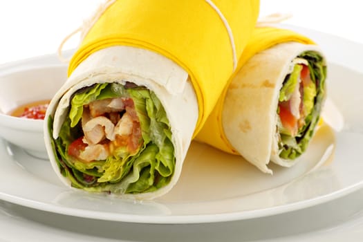 Delicious spicy chicken wraps in tortillas ready to serve.