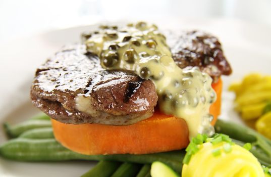 Chargrilled steak on sweet potato with green peppercorn sauce.