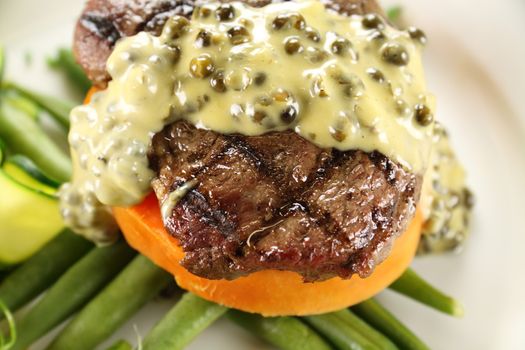 Chargrilled steak on sweet potato with green peppercorn sauce.