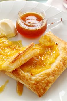 Delicious spiced pineapple galette served with cream and pineapple syrup.