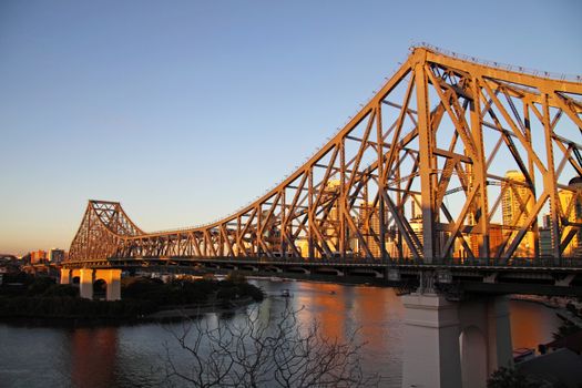 The iconic Story Bridge spanning the Brisbane River in Brisbane Australia at sunrise.