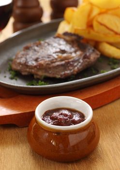 Chili ketchup sauce served with steak and potato wedges.