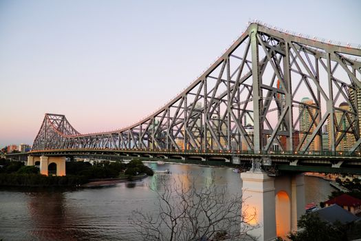 The iconic Story Bridge spanning the Brisbane River in Brisbane Australia just before sunrise.