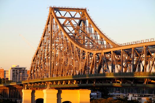 The iconic Story Bridge spanning the Brisbane River in Brisbane Australia at sunrise.