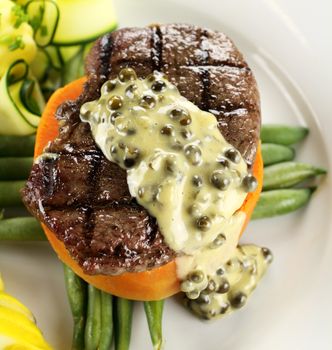 Chargrilled steak on sweet potato with green peppercorn sauce.