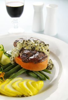 Chargrilled steak on sweet potato with green peppercorn sauce.