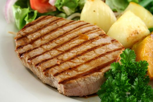 Hearty dinner of steak, vegetables and a side salad.