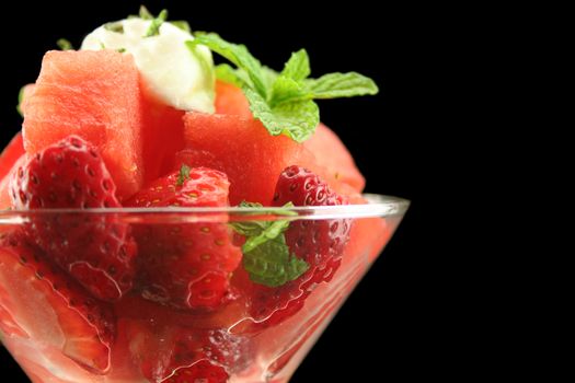 Strawberry and watermelon pieces in a glass with copy space.