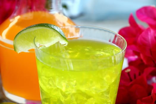 Chilled iced lime drink with a slice of fresh lime.