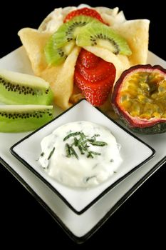 Strawberry filled pancake with passionfruit and minted yogurt.