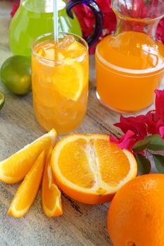 Summer drinks with fresh sliced oranges and limes ready to serve.