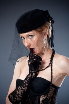 young woman with hat and veil in black corset