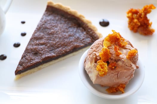 Delicious slice of chocolate tart with honeycomb and caramel ice cream.