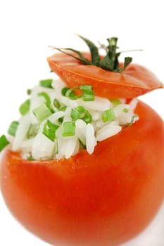 Stuffed tomato with herbed rice and garnish.