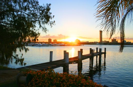 The sun sets over a jetty on the Broadwater at the Gold Coast Australia.
