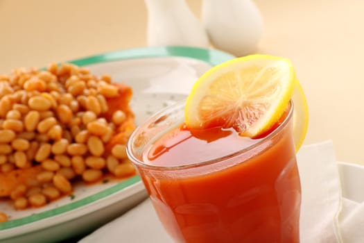 Refreshing tomato juice and lemon with baked beans for breakfast.