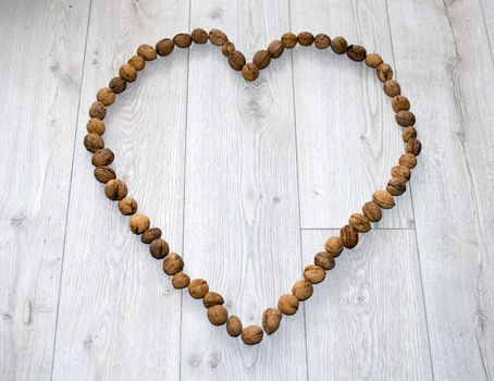 heart shape from wallnuts on floor