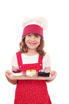 happy little girl cook hold plate with cakes