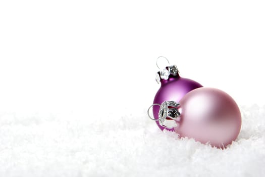 pink christmas balls on snow  