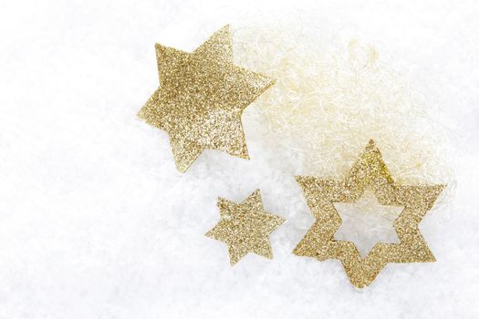 golden christmas stars on snow 