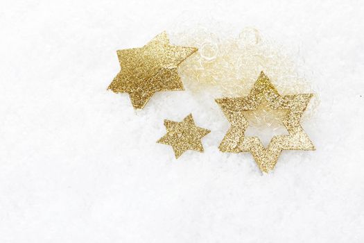 golden christmas stars on snow 