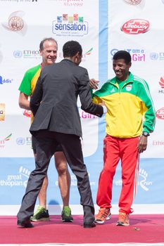 Addis Ababa, Ethiopia – November 24: World renowned athlete Haile Gebrselassie greets long-distance runner Gebremariam Gebregziabiher on stage at the 13th Edition Great Ethiopian Run, 24th of November 2013 in Addis Ababa, Ethiopia.