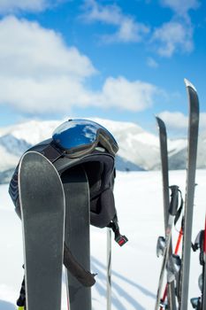 A family set of skis, ski poles in the snow mountains.