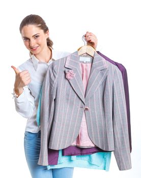 Studio picture of beautiful teenage girl with clothes. Isolated white background
