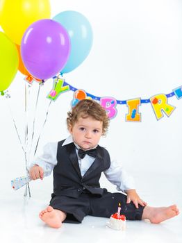 Babies' first birthday one year old with colorful balloons. Isolated over white.
