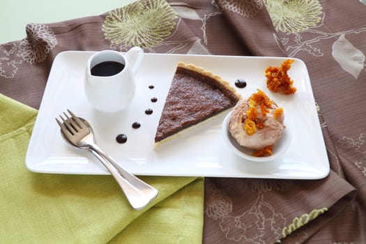 Delicious slice of chocolate tart with honeycomb and caramel ice cream.