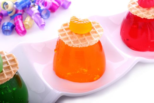 Delicious orange jelly with candy and wafer on top.