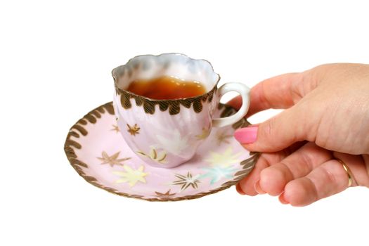 Tea in an antique tea cup served by hand.