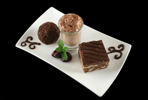 Triple chocolate treat of a rum ball and chocolate mousse and slice.