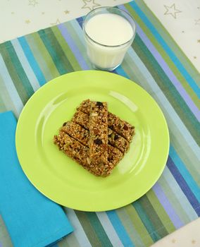 Homemade toasted muesli finger snacks and milk ready to serve.