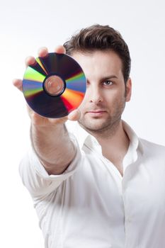 man in white shirt standing holding a CD - isolated on white
