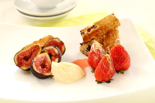 Delicious sticky glazed strawberries with chards of toffee and fresh figs and cream.