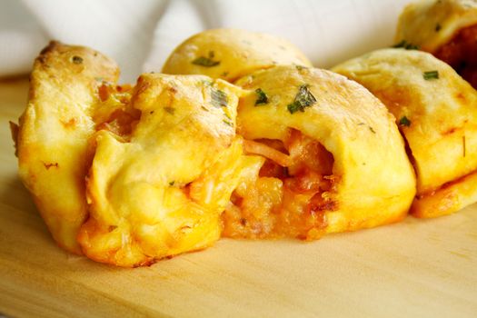 Twisted savory bread loaf with cheese, ham, pineapple and tomato filling.