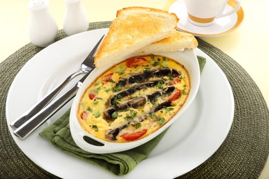 Delicious mushroom and tomato bake served with toast for breakfast.