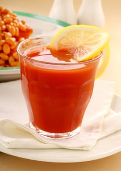 Refreshing tomato juice and lemon with baked beans for breakfast.