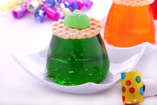 Lime flavored jelly with candy and wafer on top.