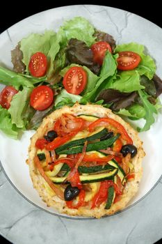 Delicious Mediterranean style vegetable and ricotta tart with salad.